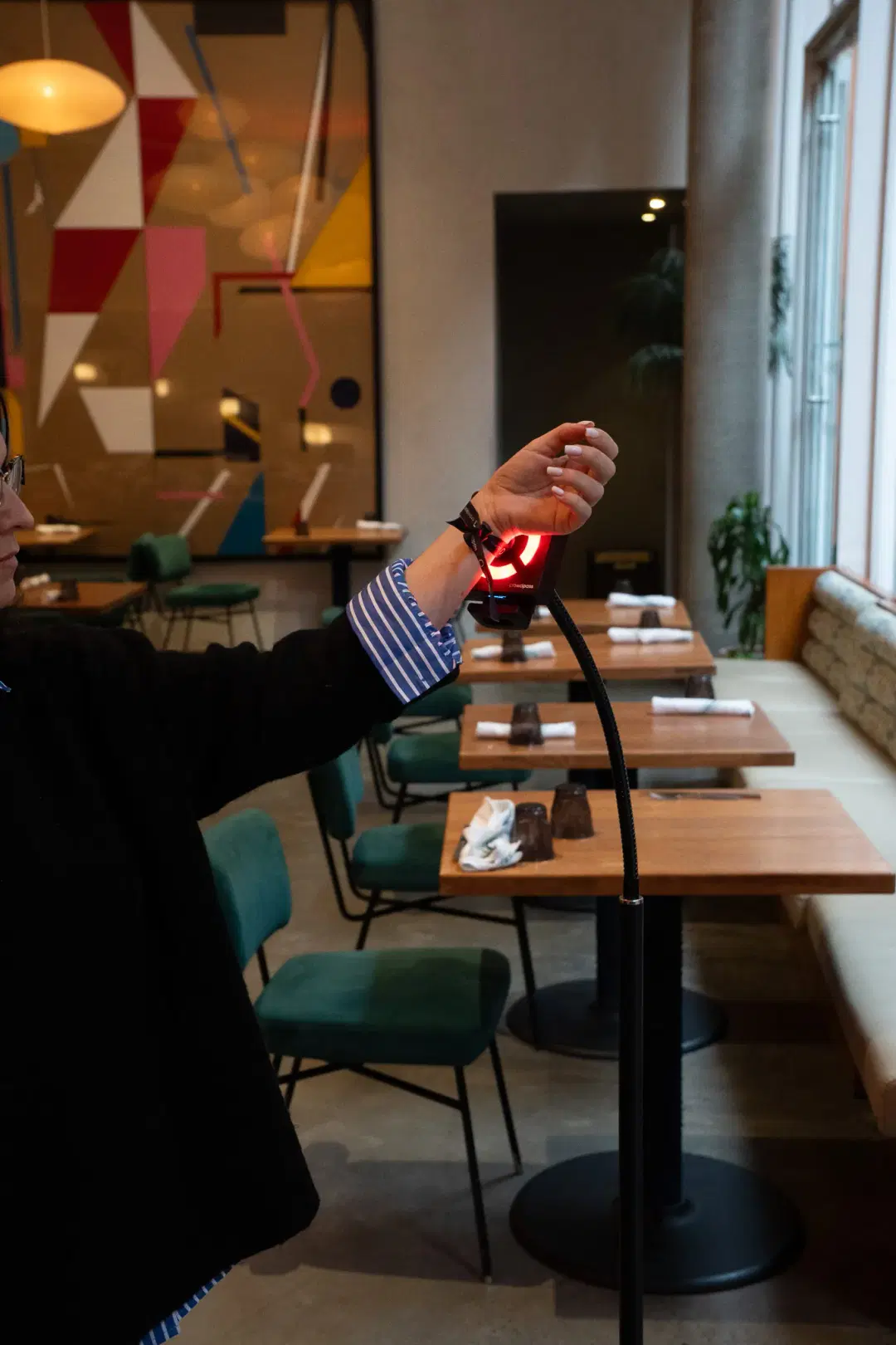 Attendee tapping wristband on CrowdReader at event check-in