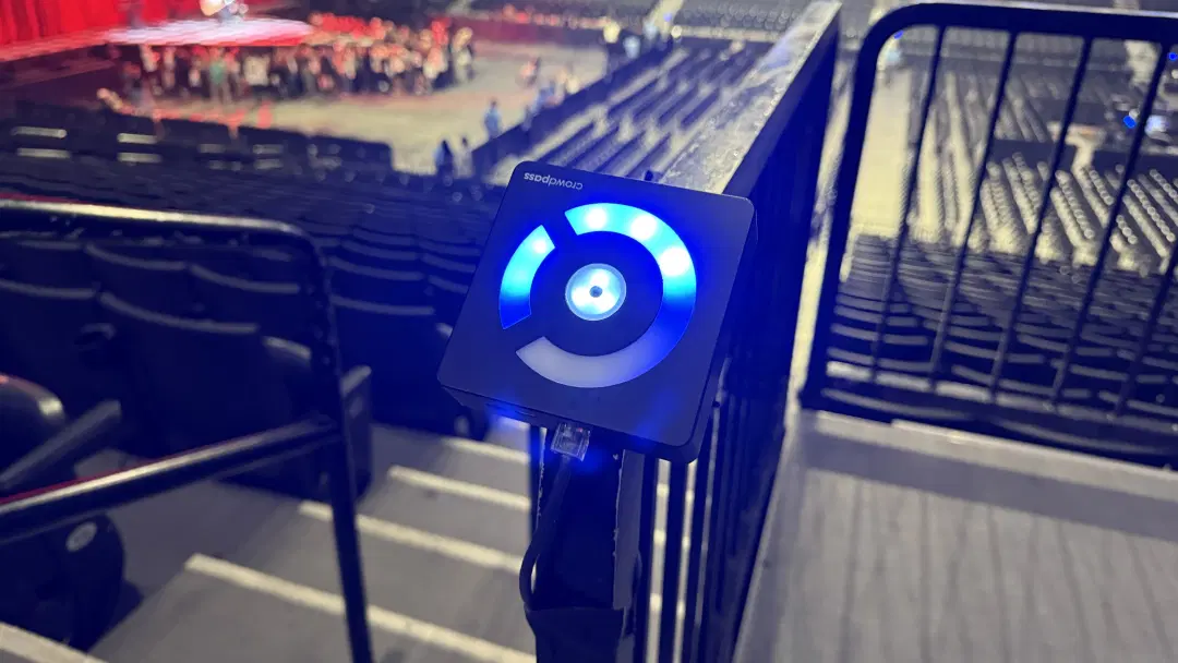 CrowdReader mounted at arena entrance with crowd in background